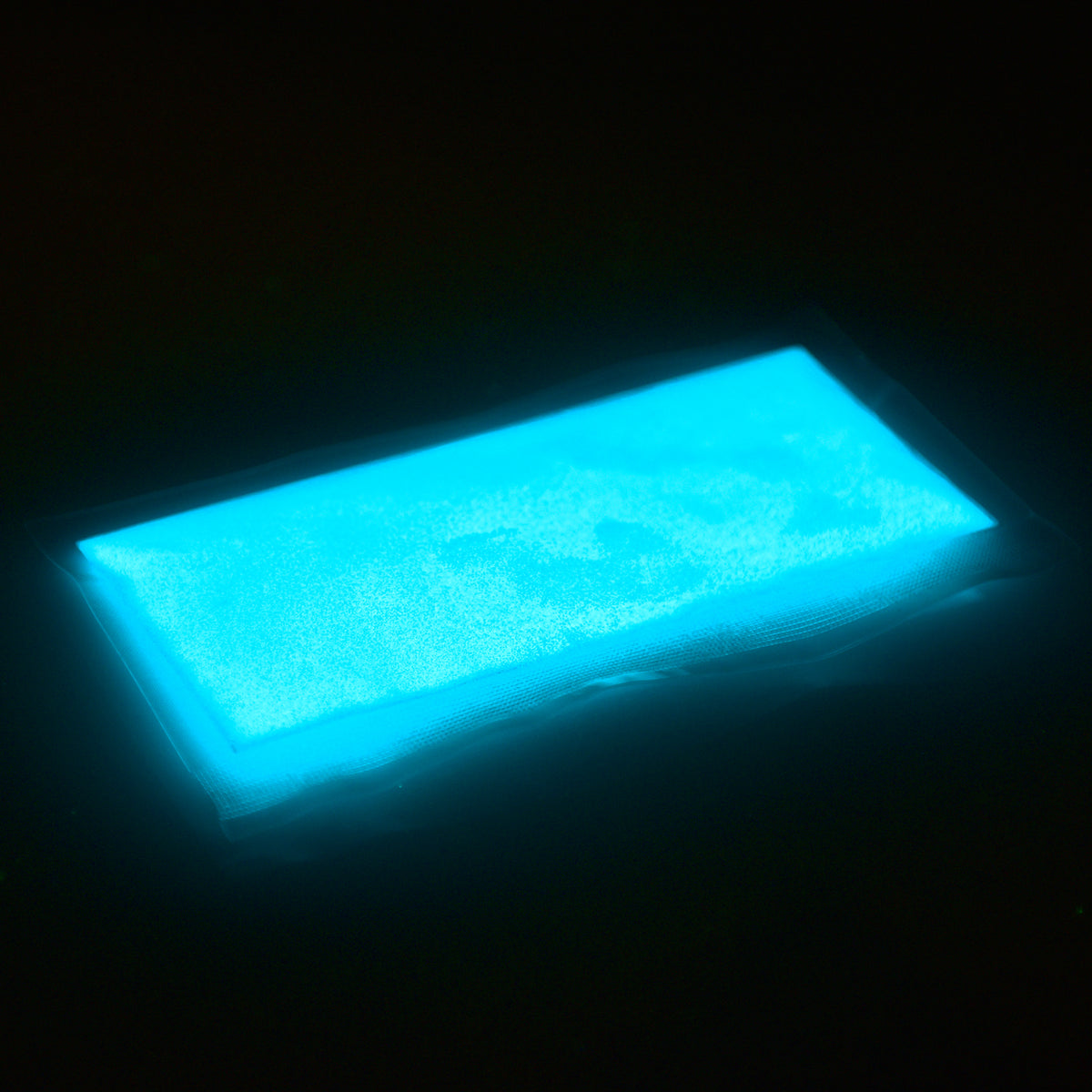 Glitzerpulver Blaugrün 50 g in der Beutelverpackung, im Dunkeln hellblau leuchtend